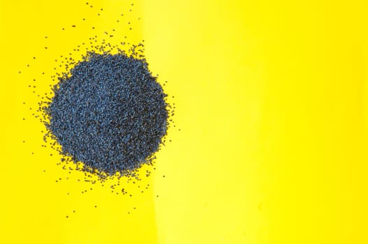 Poppy seeds isolated on yellow background poppy seed, pile of poppy seeds