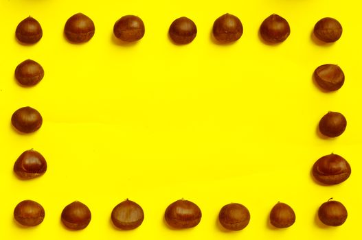 Chestnuts pattern on yellow background, top view, chestnut, castanea