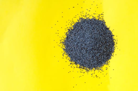 Poppy seeds isolated on yellow background poppy seed, pile of poppy seeds