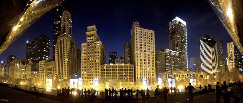 Silhouettes of people in front of  Michigan Avenue buildings.