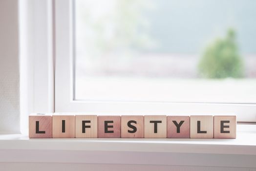 Lifestyle sign in a window in a bright room
