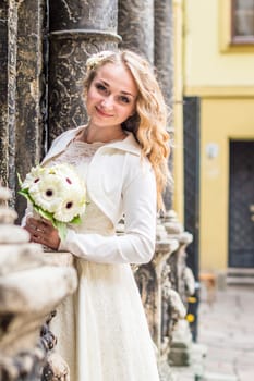 Portrait of a bride in a white dress in the city