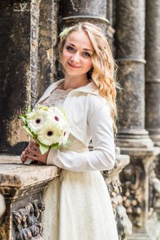 Portrait of a bride in a white dress in the city