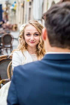 newlyweds sitting in the Cafe at the table