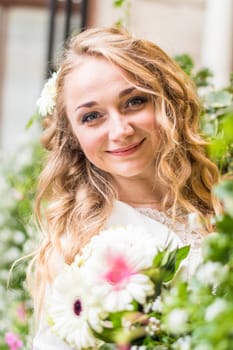 Portrait of a bride in a white dress in the city