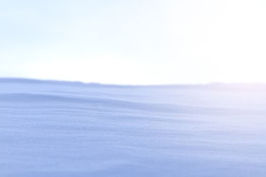snow drifts and gray sky with sunny hotspot,Winter frost and snow
