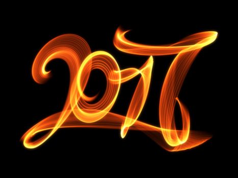 Happy new year 2017 isolated numbers lettering written with fire flame or smoke on black background.