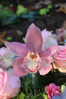 Pink roses and Cymbidium orchids wedding arrangement