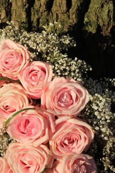 Mixed pink roses in a floral wedding decoration