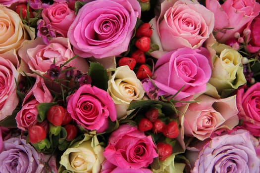 Various shades of pink roses in a wedding centerpiece
