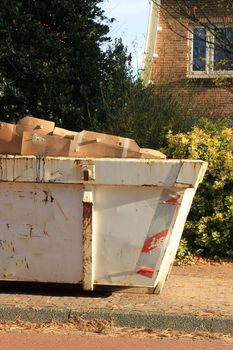 Loaded dumpster near a construction site, home renovation