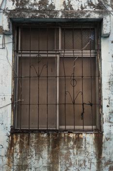 Windows with iron burgalar bars outside old house, filter