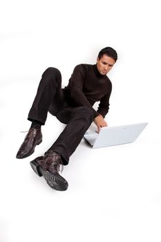 Young man working at the notebook sitting on a white background