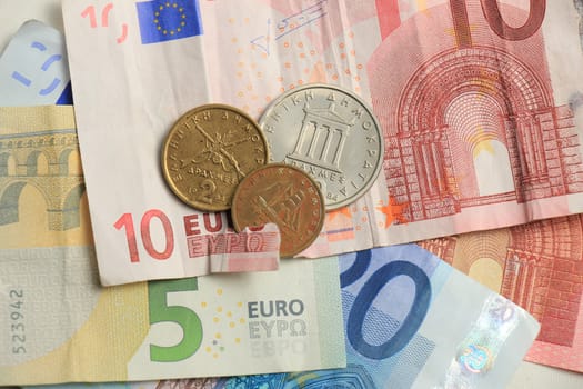 Euro crisis, a vintage Greek Drachma coin and a torn euro note