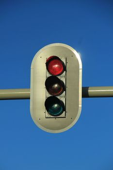 Traffic lights in a clear blue sky