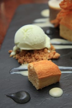 A mixed dessert with vanilla mousse, cake and icecream