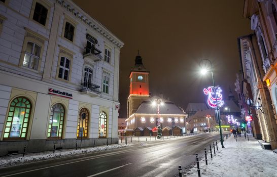 BRASOV, ROMANIA - 15 DECEMBER 2016: Brasov Council House night view decorated for Christmas and traditional winter market in the old town center, Romania