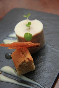 A mixed dessert with vanilla mousse, cake and icecream