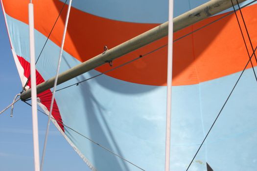 orange and white stripey sail on the end of a pole