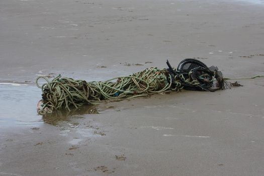 old rope abandoned on a sandy beach