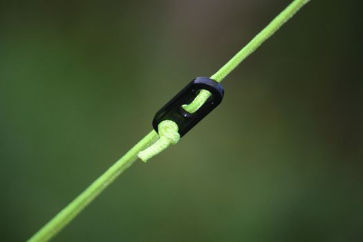 yellow guy rope with black plastic adjuster for a tent