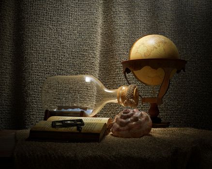 Seashell in interior scene with globe and ship in the bottle concept photo