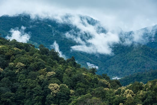 Mountains in tropical rainforest valley landscape with fog at Mon Cham, Chiang Mai, Thailand