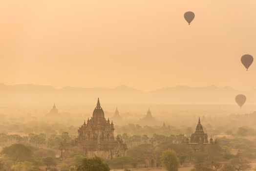 Hot air balloon over plain of Bagan in misty morning before sunrise, Myanmar