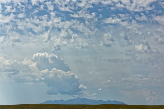 A distant mountain with beautiful clouds and sunlight overhead