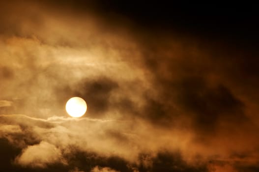 Image of the dark storm clouds and setting sun