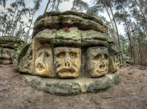 Scary Stone Heads - rock sculptures of giant heads carved into the sandstone cliffs in the pine forest above the village Zelizy in the district Melnik, Czech republic. It is the works of sculptor Vaclav Levy, who created in the period 1841-1846.