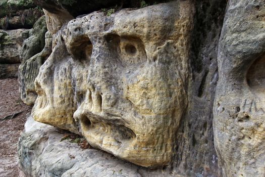 Scary Stone Heads - rock sculptures of giant heads carved into the sandstone cliffs in the pine forest above the village Zelizy in the district Melnik, Czech republic. It is the works of sculptor Vaclav Levy, who created in the period 1841-1846.