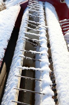 Snow covered farm equipment on a sunny day