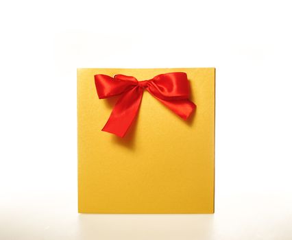 yellow paper gift bag with a Red Ribbon on a white background.