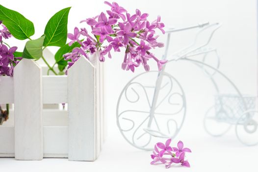 toy fence with lilac on a white background.