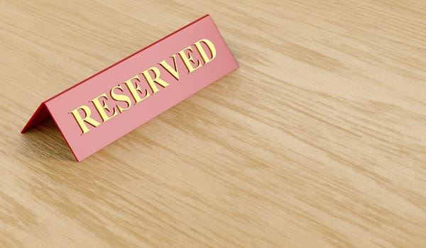 Reserved sign on wooden table 