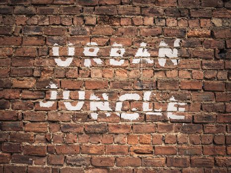 Urban Jungle Written As Graffiti On Vintage Red Brick Wall