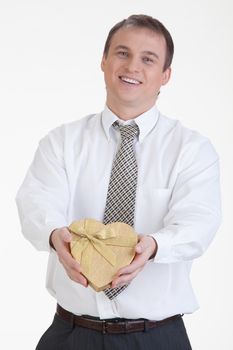 Young man with a heart shaped box in his hand on a white background