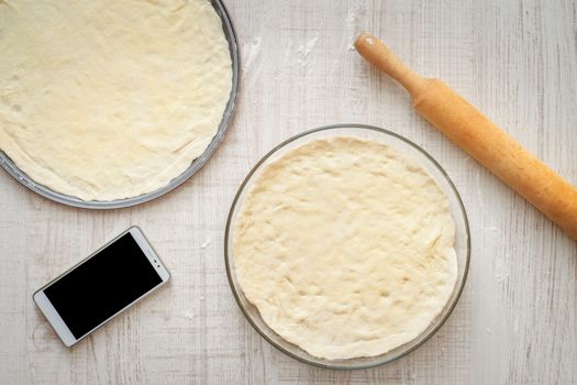 Ready dough for pizzas in forms for baking horizontal