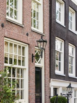 House in in a street by a canal in Amsterdam in the Netherlands
