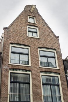 House in in a street by a canal in Amsterdam in the Netherlands