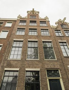 House in in a street by a canal in Amsterdam in the Netherlands