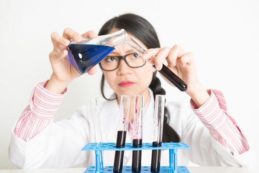 Young Asian female student in microbiological class. Research in science laboratory.