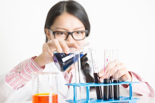 Young female researcher carrying out scientific research in a lab.