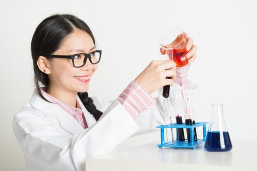 Portrait of smart and young Asian scientists doing experiment in the lab with chemistry liquid