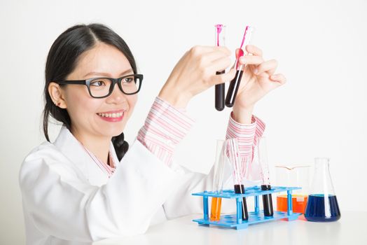 Young Asian female researcher carrying out scientific research in a lab.
