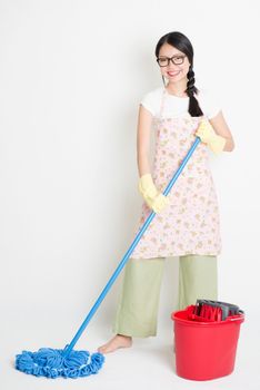 Young Asian housewife mopping floor with water, cleaning house.