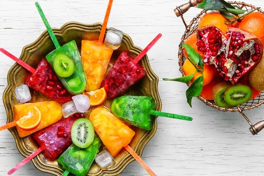 summer dish of ice cream with flavors of kiwi,pomegranate and oranges