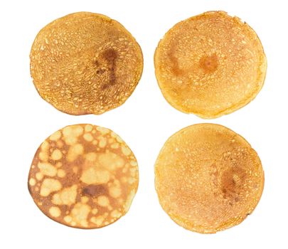 Texture of a four different round thin pancakes on a light background
