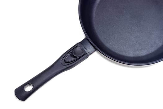 Fragment of cast frying pan, made of aluminium alloy with ceramic non-stick coating and removable handle on a light background
